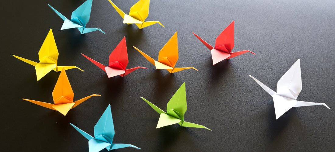 A colorful flock of origami cranes.